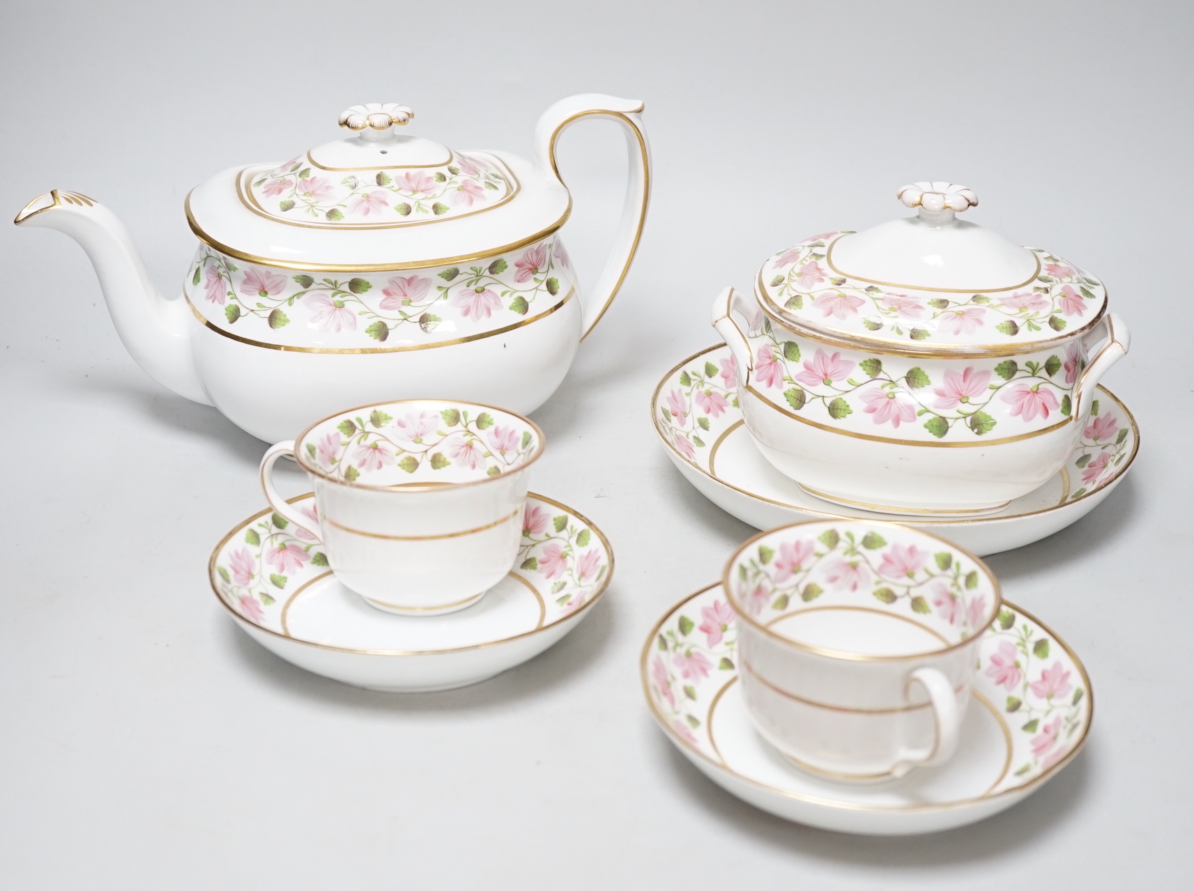 An early 19th century part tea service, teapot and cover, a sucrier and cover, two cups and saucers and a saucer-dish